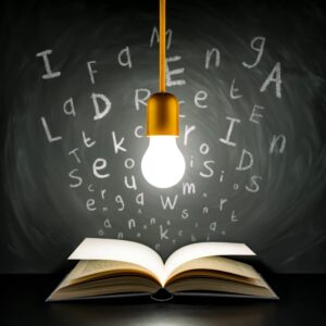 Light bulb, book and flying letters - Idea Blackboard Vintage Learning Grunge